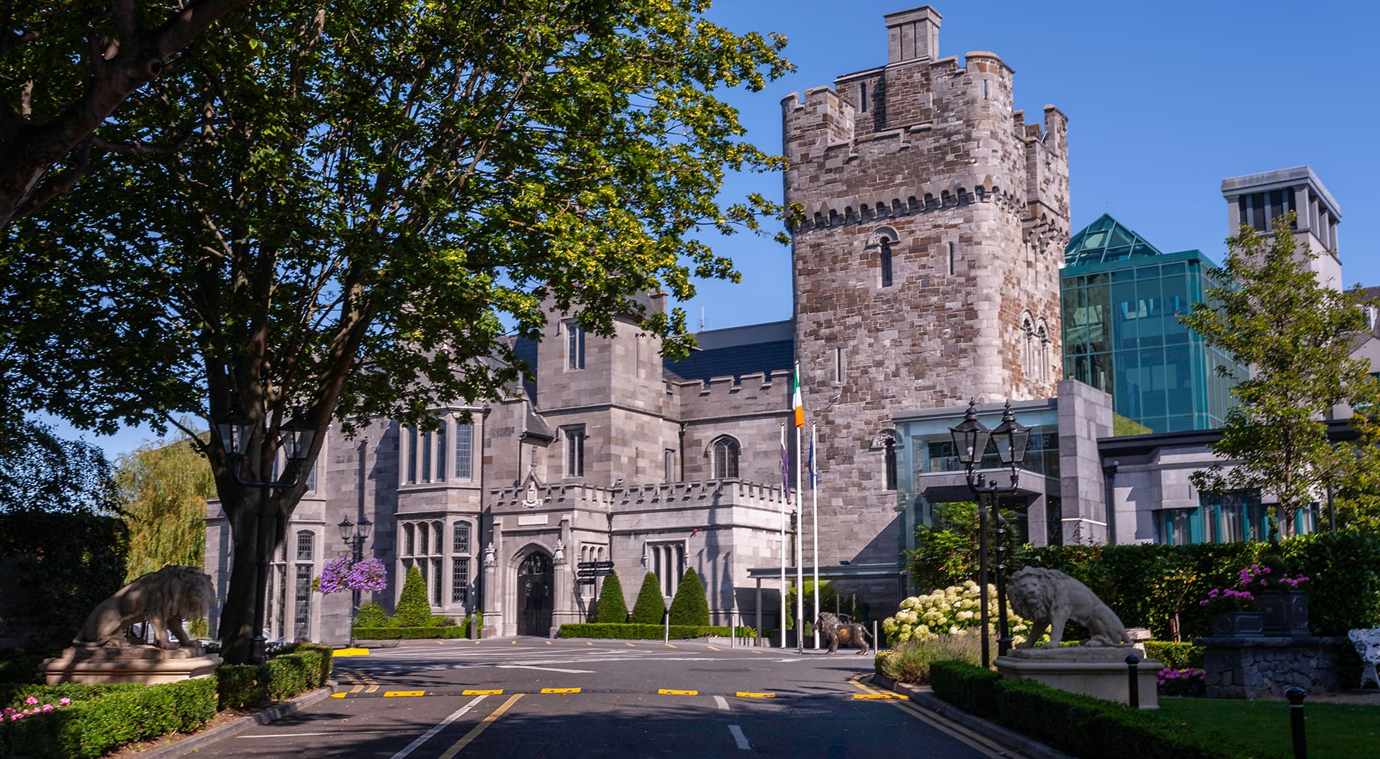 Expert Removals A castle in ireland with trees and bushes.