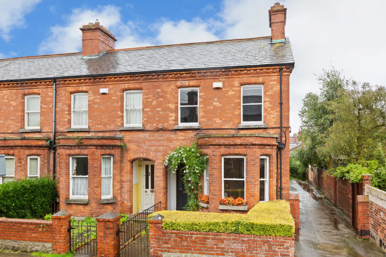 Expert Removals A red brick house in a residential area.