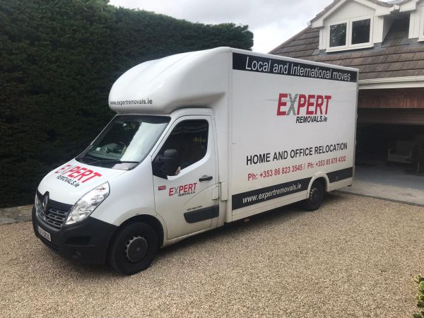 Expert Removals A white moving van parked in front of a house.