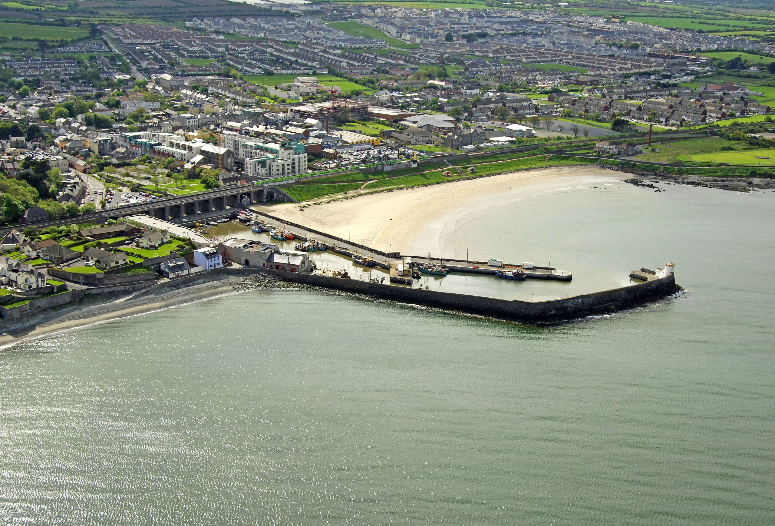 Expert Removals An aerial view of a town with a beach and a dock.